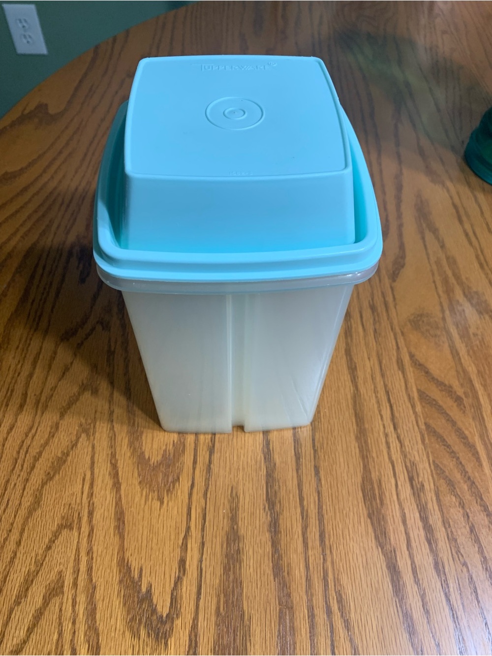 Tupperware pickle keeper with blue lid.